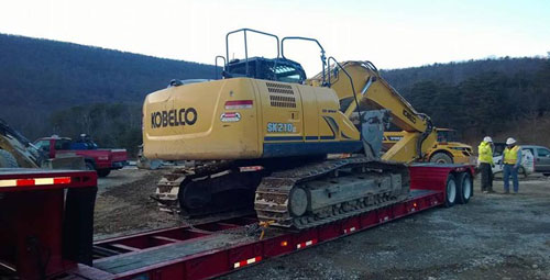 Earth moving machine being towed away